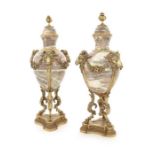 A pair of late 19th/early 20th century Louis XVI style gilt bronze mounted urns