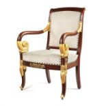 A 19th century French Empire style mahogany and parcel gilt fauteuil