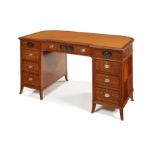 A late Victorian satinwood and polychrome decorated pedestal desk