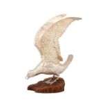 A Continental silver model of a seagull landing on a naturalistic stone base, probably German