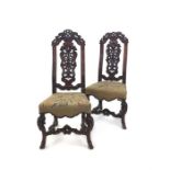A pair of 19th century carved walnut side chairs in the style of Daniel Marot