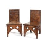 A pair of Victorian Gothick Revival armorial hall chairs