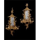 A pair of George III style giltwood carved girandoles