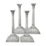 A set of four George III silver Corinthian column candlesticks with filled bases, by William Abdy (