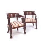 A large pair of Louis Phillipe mahogany tub shaped bergère armchairs