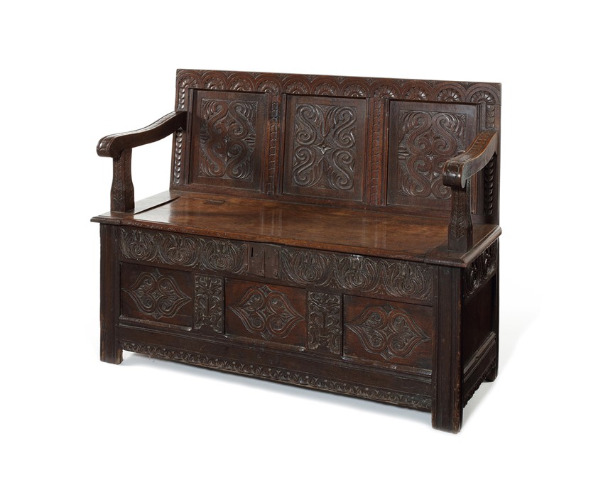 A small oak box-seat settle, circa 1900, adapted from a 17th century chest