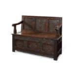 A small oak box-seat settle, circa 1900, adapted from a 17th century chest