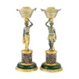 A pair of Continental parcel-gilt and partly oxidised silver, granite and nephrite candlesticks
