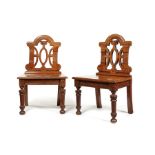 A pair of Victorian Renaissance Revival pollard oak hall chairs