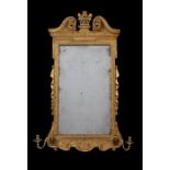 A George II Irish giltwood carved mirror/ girandole
