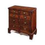 An early George II burr walnut crossbanded and featherbanded bachelors chest