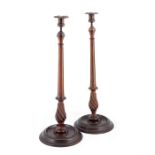 A large pair of George III style mahogany candlesticks