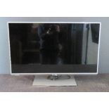 A Panasonic flat screen TV, 32 inch, with remote control.