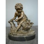 A bronze figure of a boy with chickens, 31cm high.