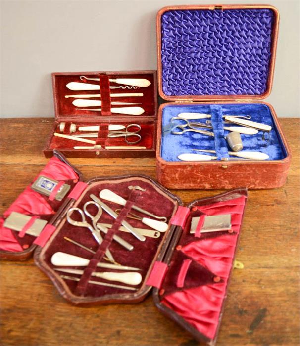 Three Edwardian sewing kits, two with mother of pearl and one with bone handles.