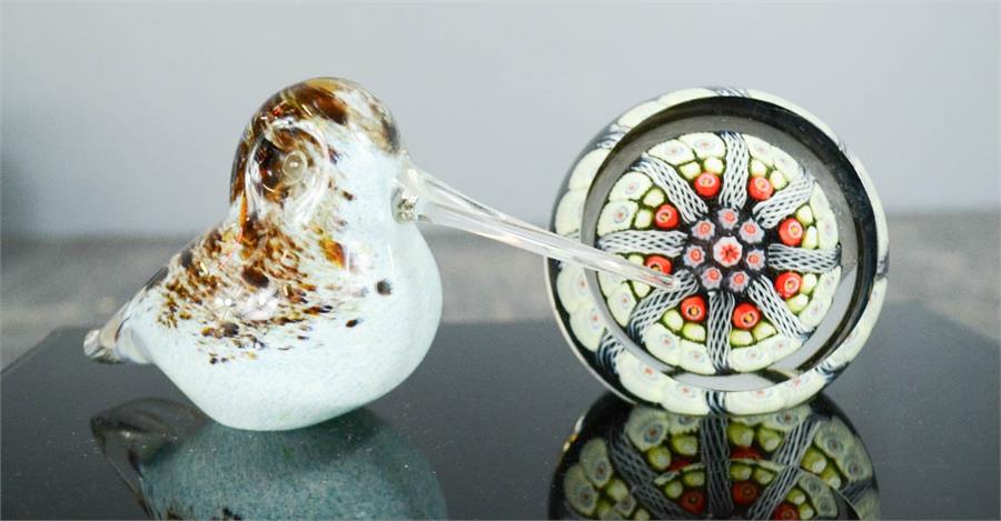 A mille fiori glass paperweight, and a glass paperweight in the form of a curlew.
