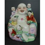 A Chinese ceramic Buddha. 31cm high, width 25cm