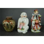 A Chinese ceramic figure of Buddah, a vase and a figure group.Buddah 33cm high, group 35cm high,
