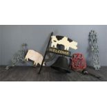 A group of cast iron ware, including a welcome sign in the form of a pig with bell, a wall bracket