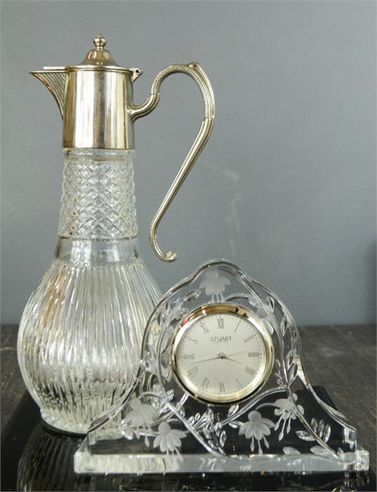 A Stuart crystal mantle clock etched with Fuchsia's, together with a Claret jug with silver plated