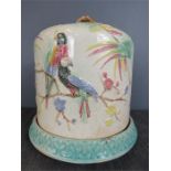 A Victorian stoneware cheese dish and cover, modelled with parrots and palms. 30cm height, 26cm