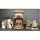 A group of four ceramic elephants, the largest measures 42cm high by 28cm diameter.