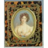 A 19th century miniature portrait of young woman with blue eyes and wearing a sapphire brooch, in