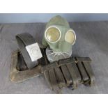 A WWII German belt, gas mask, ammo pouch and spade cover.