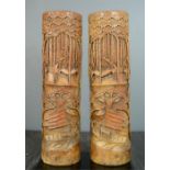 A pair of Japanese carved brush pots, depicting figures on boats, 40cm high.11cm diameter