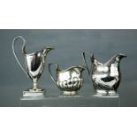 Three silver jugs; Birmingham 1910, London (worn hallmarks) and Birmingham 1911, 7.04toz.