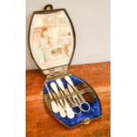 A Victorian manicure/sewing set, in leather bound case with mirrored back, blue velvet lining, and