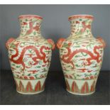 A pair of 20th century Chinese vases decorated with red dragons.