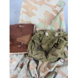Two WWII German backpacks, one canvas, the other fur fronted, together with a camouflage ground