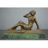 A bronze figure of a reclining woman, 19cm high, plinth length 26cm.