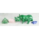 A malachite carved rhinoceros, a green jade Buddha, rose quartz pig, lapiz lazuli turtle.