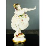 A Dresden porcelain figure of a woman, 19th century, bearing makers mark to the base. 19cm tall
