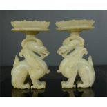 A pair of rare Chinese white jade candle stands, in the form of dragons, with removable candle