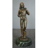 A bronze figure of a lady holding a bag, 31cm high.