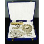 A silver dressing table set, Birmingham, comprising hair brush, comb, mirror and clothes brush, in a