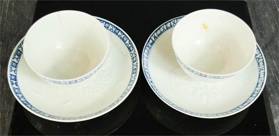 A pair of early English tea bowls and saucers, embossed with flowers, blue and white borders. - Image 2 of 3