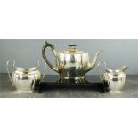 A silver three piece silver tea service comprising tea pot, cream jug and sugar bowl, Birmingham