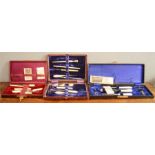 Three Edwardian sewing sets, each boxed and containing mother of pearl or bone handled implements.