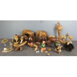 A quantity of treen items including carved elephants, Swiss bottle stop, 1970s comical carved