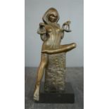 A bronze figure of a lady holding scales, 29cm high. 20cm wide