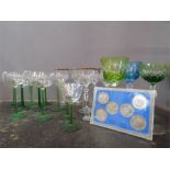 A group of coloured cut crystal glasses of various design, together with a commemorative set of Isle