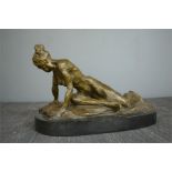 A bronze figure; female reclining nude, 32cm wide.20cm high