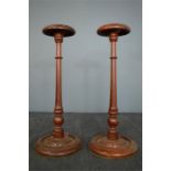 A pair of treen wig stands, 39cm high.