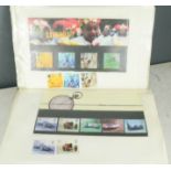 Philately: an album of GB First Day Covers, and Royal Mint Stamps, in booklet and loose form.