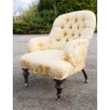 A Victorian mahogany armchair, with yellow silk upholstery and button back. [Provenance: Gumley
