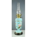 A Victorian turquoise glass paraffin lamp painted with flowers.